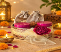 Festive Radiance hamper in a woven tray with tins and diya